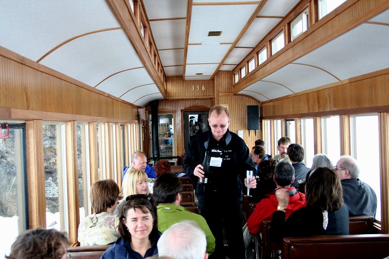 Michael Brandt serves champagne for a special toast at the Summit before crossing into Alaska. 